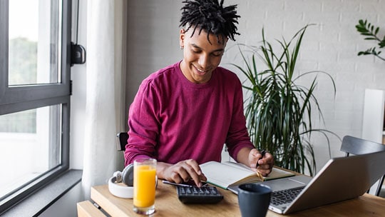 Young man reviews his personal finances online.